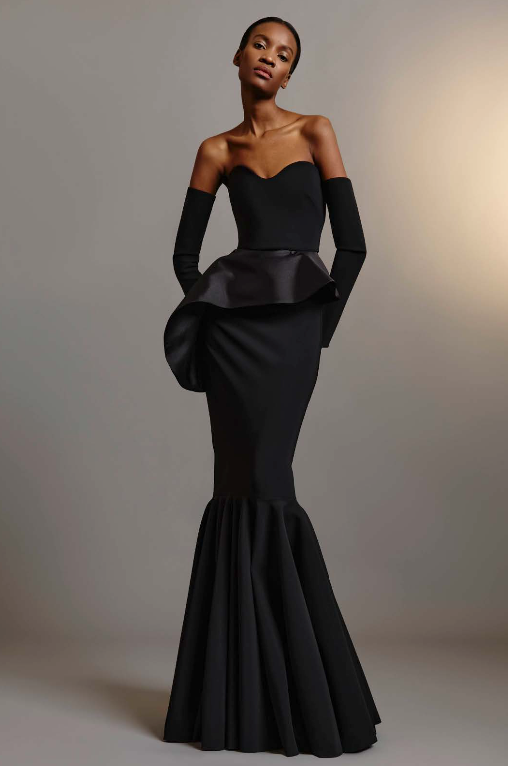 Model wearing Greta Constantine Breuer gown with detachable gloves, contrast peplum, and flounce hem.