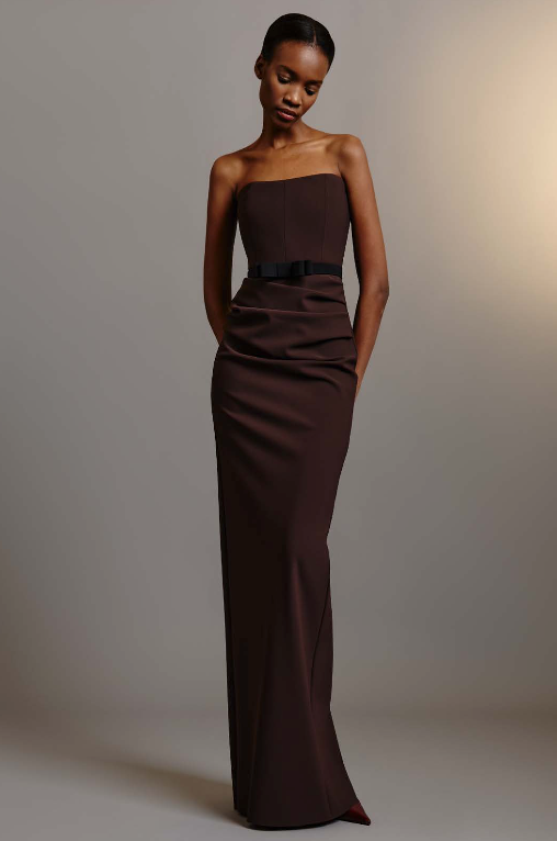 Model wearing Greta Constantine Moseph strapless ruched gown with fitted bodice and floor-length silhouette.