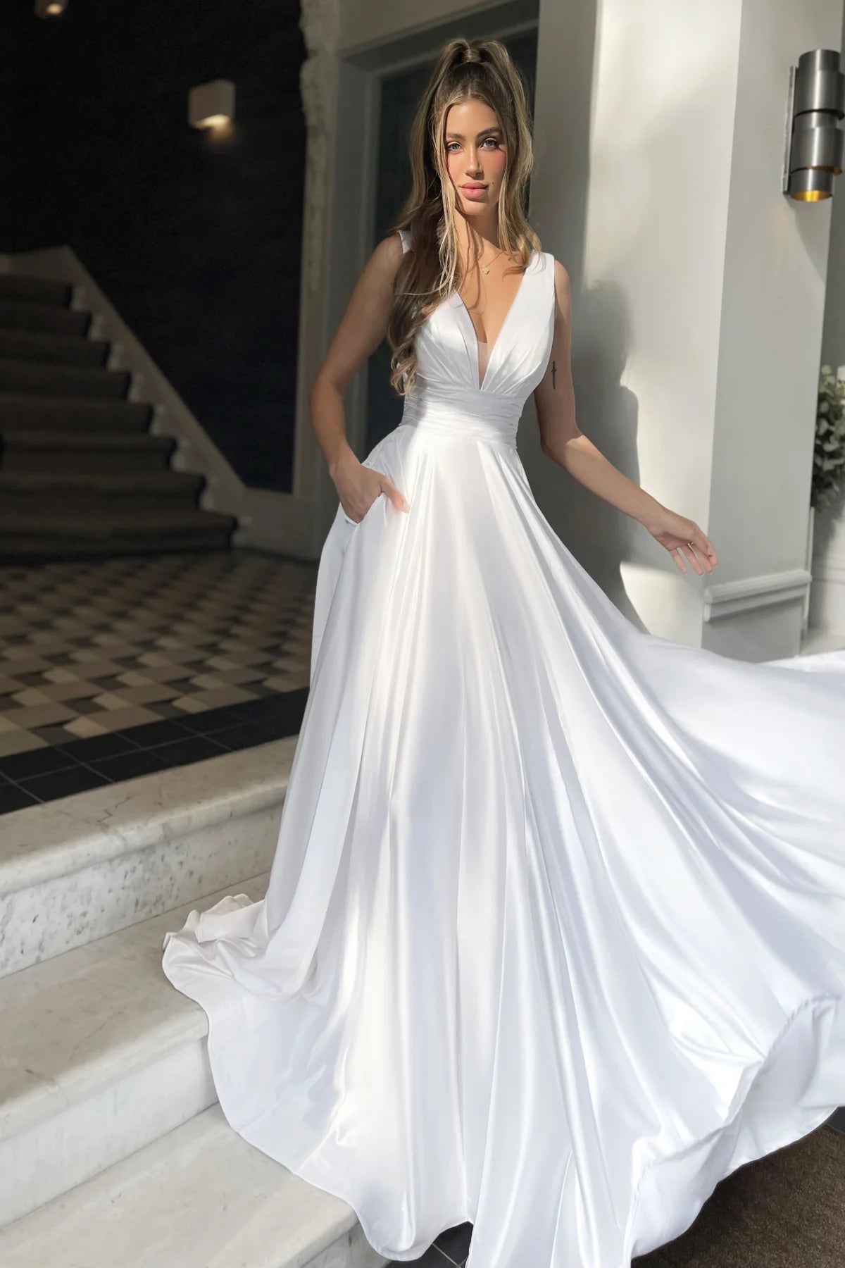 A beautiful satin A-line dress by Jadore, featuring a plunging neckline and slender straps, perfect for bridesmaids, prom, or special occasions.  Available at Madeline's Boutique in Boca Raton and Toronto, Ontario.
