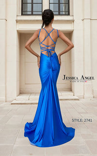 A woman stands with her back to the camera wearing a bright royal blue floor-length gown with a crisscross lace-up open back, photographed outdoors in front of a beige stone building. Visible text includes the brand name Jessica Angel and style number 2741.