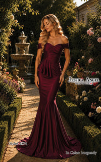 A woman models an off-the-shoulder burgundy mermaid-style gown in a sunlit garden path with hedges, flowers, and a fountain. The dress has a sweetheart neckline, fitted silhouette, peplum waist, and a slight train.
