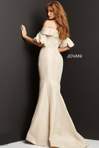 Model wearing Jovani 06831 off-the-shoulder puff sleeve mermaid gown with crossover bodice.