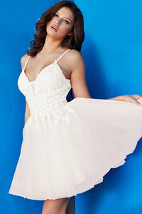 Jovani 08273 Floral Fit and Flare Cocktail Dress, a charming choice for homecoming or cocktail events. The dress features a floral bodice and a flattering fit-and-flare silhouette.  Picture is of the model wearing the dress in Ivory..