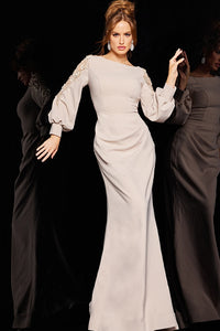 A woman wearing a floor-length evening dress with sheer sleeves adorned with floral appliques, perfect for formal occasions.