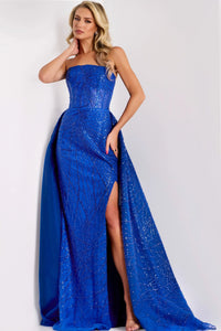 Model wearing Jovani 39029 strapless A-line gown with sequin embellishments and flowing overlay.