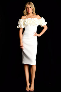 Woman wearing a white off-shoulder dress with ruffled details against a black background