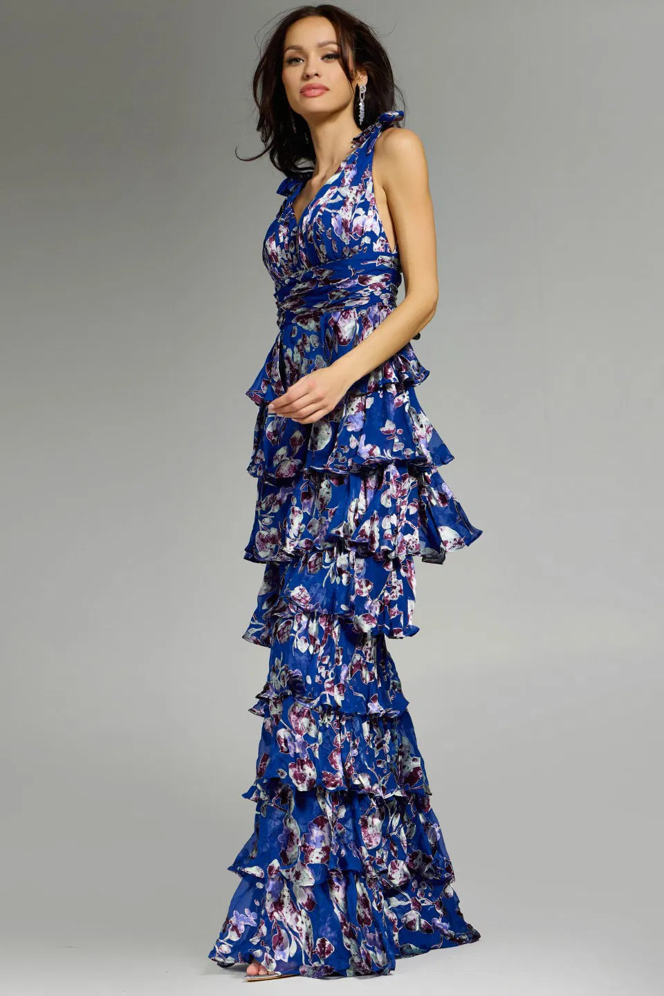 Jovani 42381 Ruffled Floral Gown featuring cascading ruffled tiers, floral print, plunging neckline, and shoulder ties for formal occasions.
