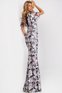 Model wearing Jovani 43046 sequin gown with flutter sleeves, V-neckline, and open back with tie detail.