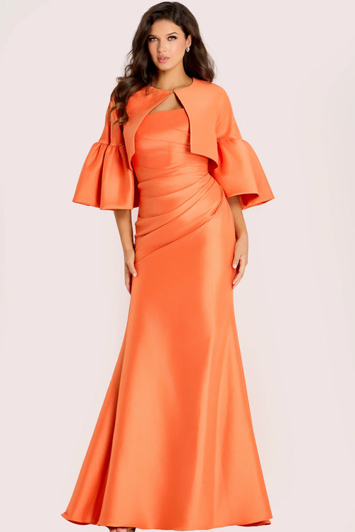A woman modeling a floor-length orange gown with a draped cape-style collar, flared elbow-length sleeves, and a fitted mermaid silhouette against a plain light background.