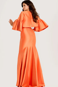 Woman wearing an orange dress with ruffled sleeves on a light gray background