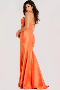 Woman wearing an orange strapless gown on a white background