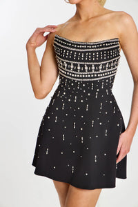 Model wearing Jovani 45220 strapless fit and flare cocktail dress with rhinestone bodice and allover crystal beading.  Color of dress in the picture is black.