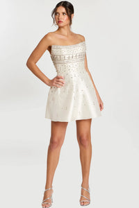 Model wearing Jovani 45220 strapless fit and flare cocktail dress with rhinestone bodice and allover crystal beading.  Color of dress in the picture is off-white.
