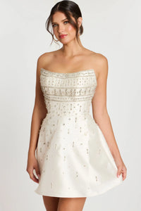 Model wearing Jovani 45220 strapless fit and flare cocktail dress with rhinestone bodice and allover crystal beading.  Color of dress in the picture is off-white.