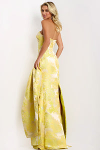 Model wearing Jovani 45289 strapless floral column gown with straight neckline, high slit, and matching drape.  Back View.