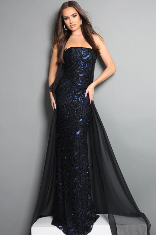 Woman wearing a black and blue evening gown against a gray background