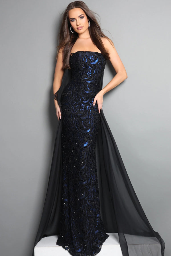 Woman wearing a black and blue evening gown against a gray background