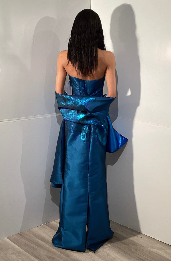 Model wearing Jovani 45577 strapless mermaid gown with a matching wrap, fitted silhouette, detailed bodice, and sweep train.