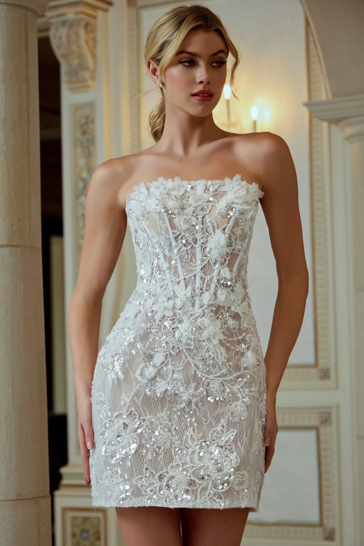 Woman wearing a strapless lace dress in an elegant interior setting