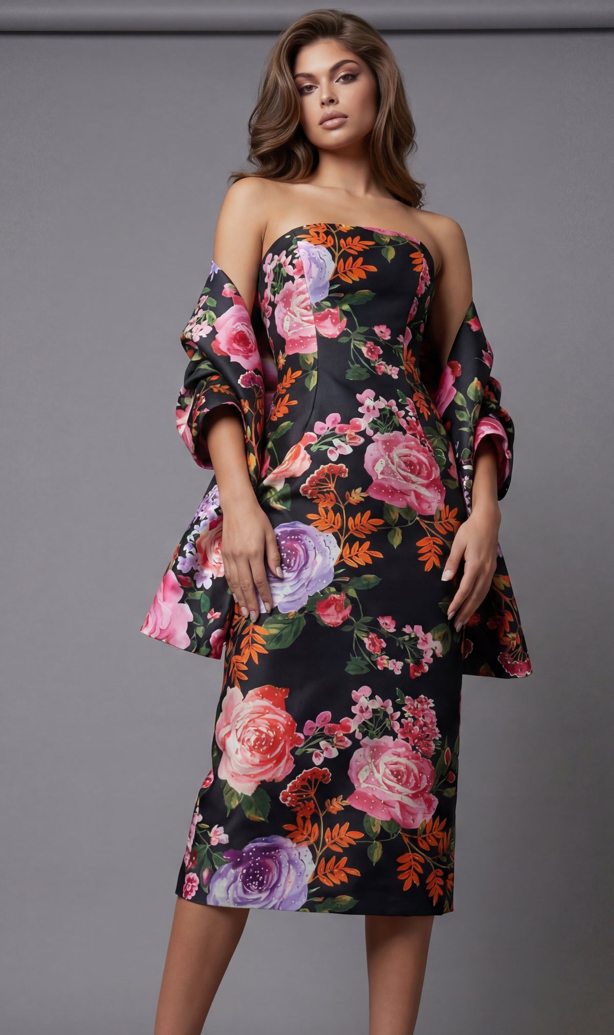 Woman wearing a floral off-shoulder dress against a gray background