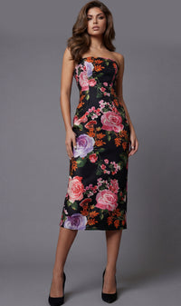Woman wearing a strapless floral dress against a gray background