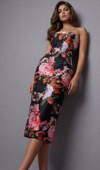 Woman wearing a floral dress against a gray background
