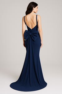 Model wearing Jovani 47669 sleeveless fitted gown with draped bodice, bow back detail, and sweep train.