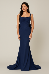 Model wearing Jovani 47669 sleeveless fitted gown with draped bodice, bow back detail, and sweep train.