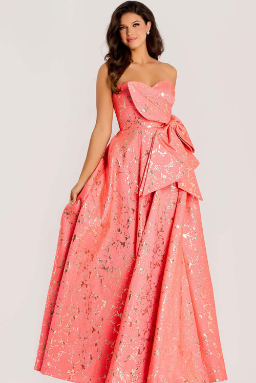 Woman wearing a pink strapless gown with a large bow on a white background