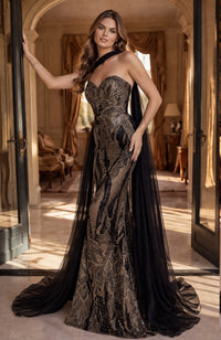 Model wearing Jovani 48709 beaded strapless mermaid gown with dramatic detachable cape.
