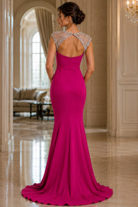 Woman in a fuchsia evening gown with a beaded back in an elegant interior setting