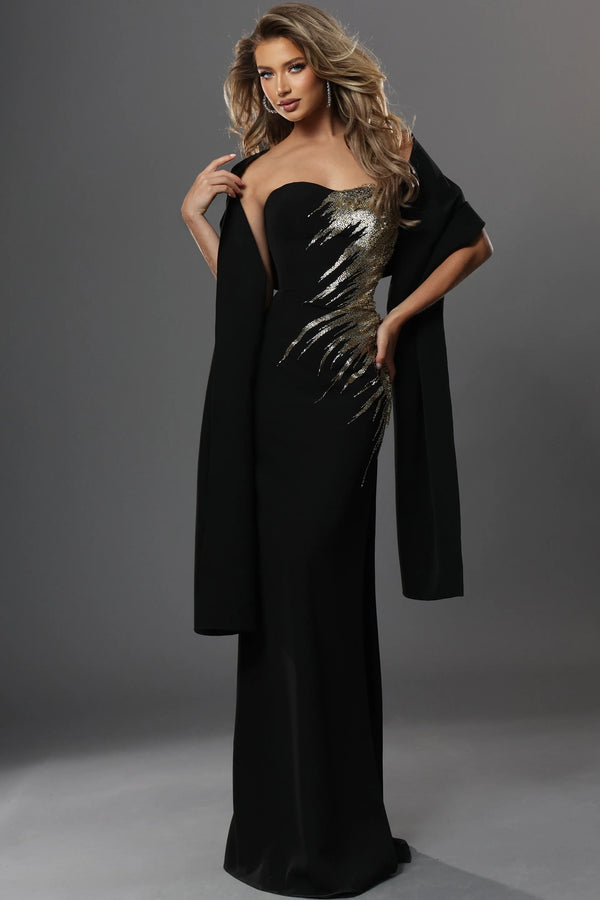 Woman wearing a black evening gown with a metallic overlay on a gray background