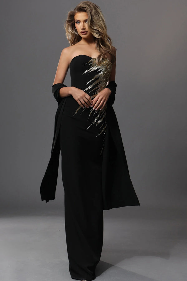 Woman wearing a black strapless gown with metallic accents on a gray background