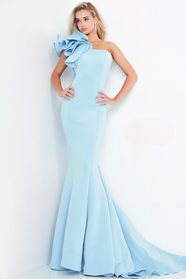 A stunning scuba mermaid evening dress by Jovani . It has a one-shoulder flower ruffle detail bodice and straight neckline, perfect for special events and Black Tie occasions. The picture of the dress is dark green. It is available at Madeline’s Boutique in Boca Raton, Florida and Toronto, Canada.
