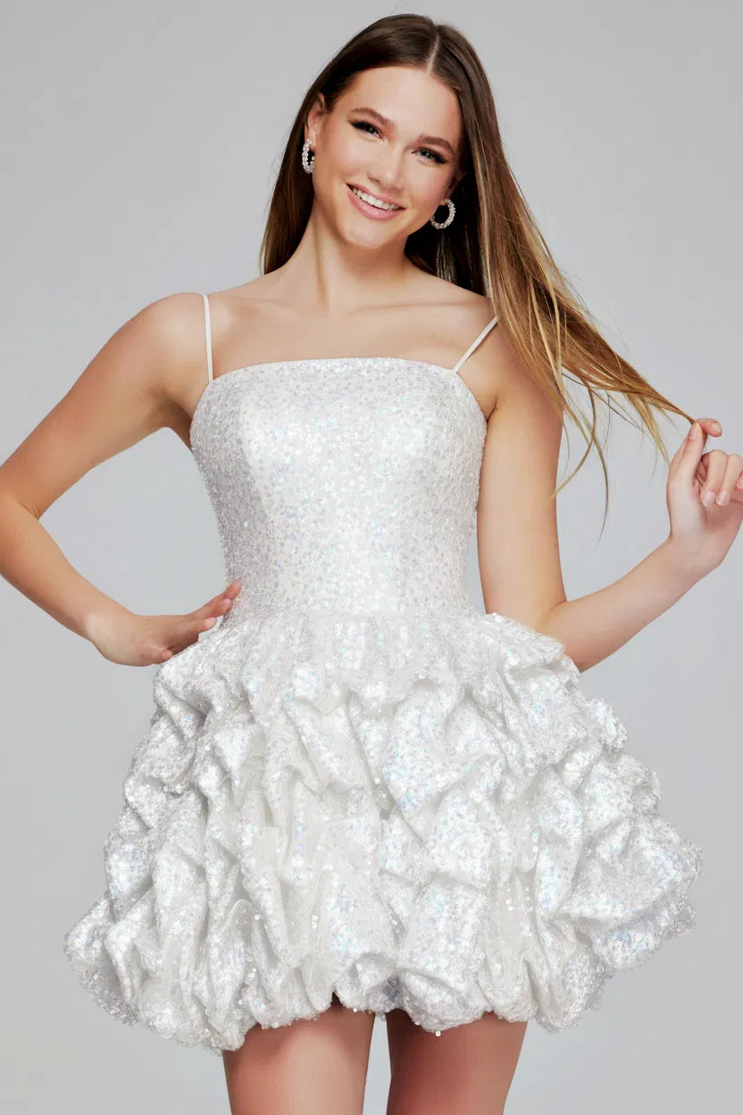 Woman wearing a white sequin dress against a gray background