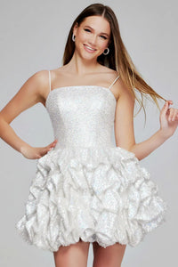 Woman wearing a white sequin dress against a gray background