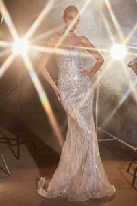 Shine in the spotlight with La Divine CC6018, a stunning evening gown featuring a fitted silhouette, strapless pointed neckline, and dazzling rhinestone embellishments. Perfect for an evening event, this gown promises glamour and sophistication. The model is wearing the dress in silver nude.