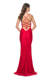 La Femme 31618 Chic Fitted Long Jersey Prom Dress - A sophisticated prom dress with a chic fitted silhouette, ruching detail, criss-cross style bodice, and an open back with a lace-up tie.  Model is wearing the dress in the color red.