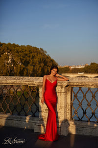 La Femme 31618 Chic Fitted Long Jersey Prom Dress - A sophisticated prom dress with a chic fitted silhouette, ruching detail, criss-cross style bodice, and an open back with a lace-up tie. Model is wearing the dress in the color red.