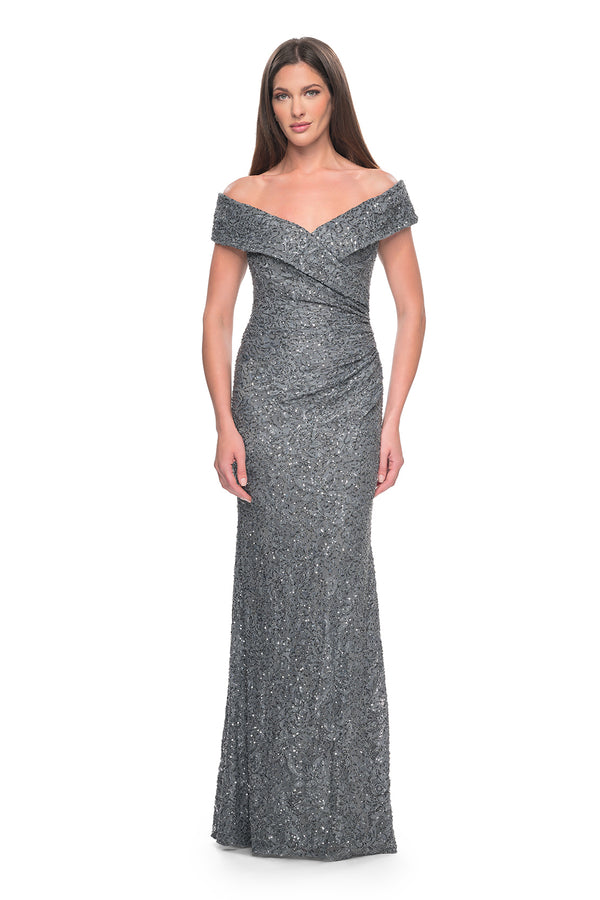 La Femme 31679 Enchanting Beaded Lace Off-the-Shoulder Evening Gown - A breathtaking ensemble featuring intricate beaded lace, off-the-shoulder design, ruching details, and a flattering V neckline for a look of timeless elegance.  The model is wearing the dress in the color gunmetal.