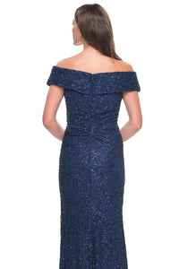 La Femme 31679 Enchanting Beaded Lace Off-the-Shoulder Evening Gown - A breathtaking ensemble featuring intricate beaded lace, off-the-shoulder design, ruching details, and a flattering V neckline for a look of timeless elegance. The model is wearing the dress in the color navy. Back View.