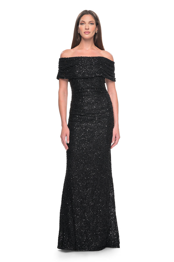 La Femme 31778 Elegant Off-the-Shoulder Lace Evening Gown - A fitted and elegant long dress adorned with exquisite beaded lace, featuring an off-the-shoulder neckline and meticulous ruching.  The model is wearing the dress in the color black.