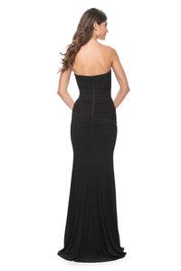 La Femme 31899 Ruched Net Jersey Sweetheart Prom Dress - A long prom dress with ruched net jersey, sweetheart neckline, and illusion detail with exposed boning on the back and waist for a modern and alluring look. The model is wearing the dress in the color black.  Back view of the dress.