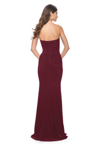 La Femme 31899 Ruched Net Jersey Sweetheart Prom Dress - A long prom dress with ruched net jersey, sweetheart neckline, and illusion detail with exposed boning on the back and waist for a modern and alluring look. The model is wearing the dress in the color dark berry.