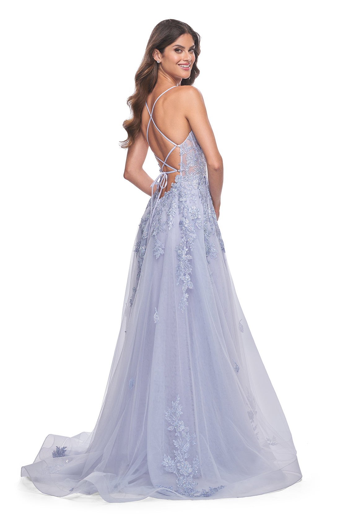 La Femme 32062 A-Line Lace Applique Prom Gown - An enchanting A-line gown featuring a deep v-neck, high slit, lace applique embellished bodice, lace detailed hem, and a charming tie-up back. Perfect for prom or a quinceañera. Model is wearing Light Periwinkle.