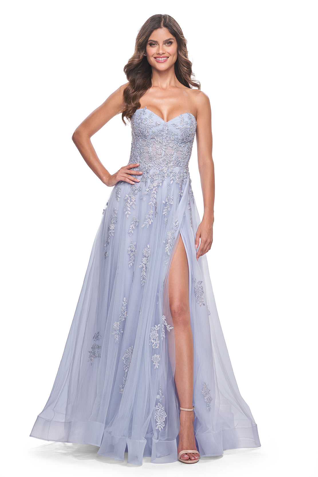 La Femme 32084 A-Line Prom and Quinceañera Gown with Lace Applique - An enchanting A-line gown featuring delicate ruched detail, a lace-up bodice, sweetheart neckline, and intricate lace applique for a statement look at prom or quinceañera celebrations. The dress in the picture is light periwinkle.