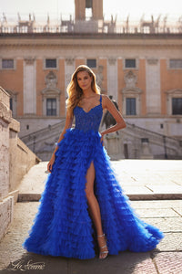 La Femme 32128 Dreamy Ruffle Tulle Tiered Prom Dress - A captivating prom dress featuring a dreamy ruffle tulle tiered skirt, high slit, and intricate lace applique details for an enchanting and sophisticated look. The model is wearing royal blue.