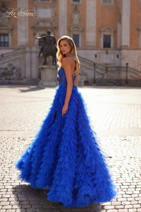 La Femme 32128 Dreamy Ruffle Tulle Tiered Prom Dress - A captivating prom dress featuring a dreamy ruffle tulle tiered skirt, high slit, and intricate lace applique details for an enchanting and sophisticated look. The model is wearing royal blue.