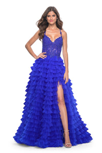 La Femme 32128 Dreamy Ruffle Tulle Tiered Prom Dress - A captivating prom dress featuring a dreamy ruffle tulle tiered skirt, high slit, and intricate lace applique details for an enchanting and sophisticated look. The model is wearing royal blue.