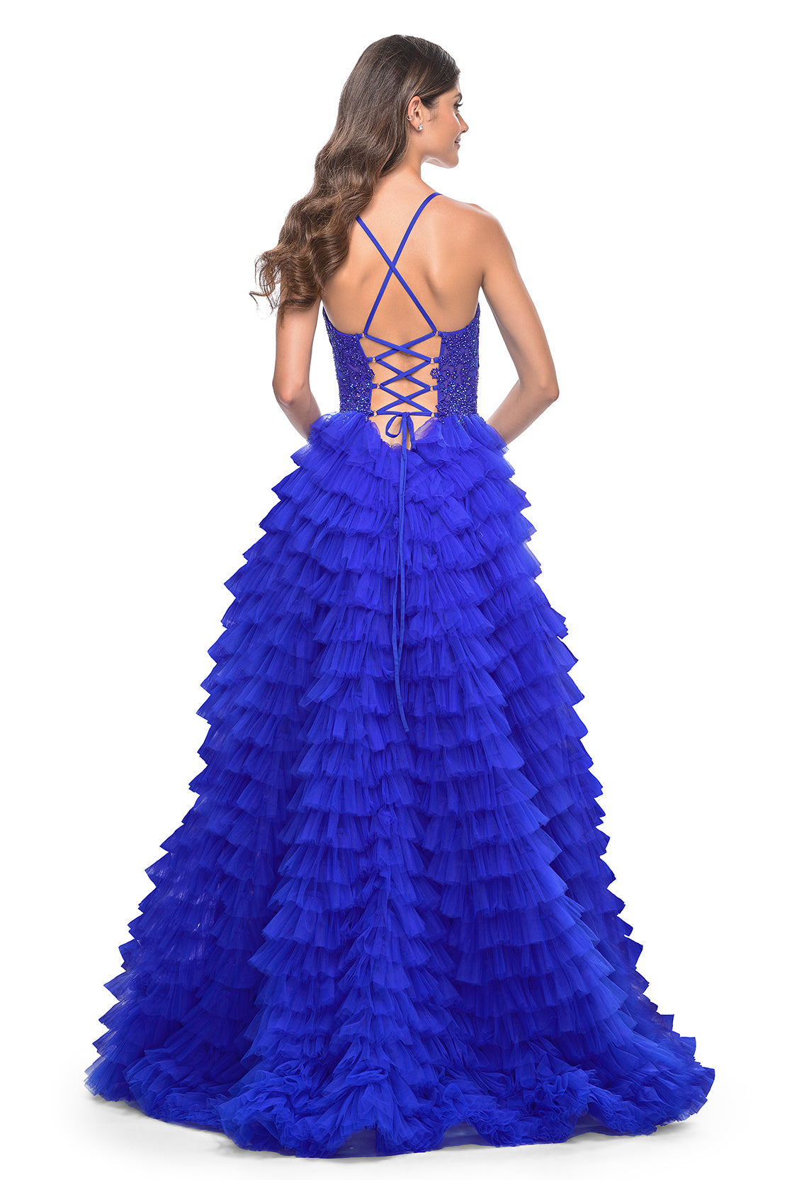 La Femme 32128 Dreamy Ruffle Tulle Tiered Prom Dress - A captivating prom dress featuring a dreamy ruffle tulle tiered skirt, high slit, and intricate lace applique details for an enchanting and sophisticated look. The model is wearing royal blue.